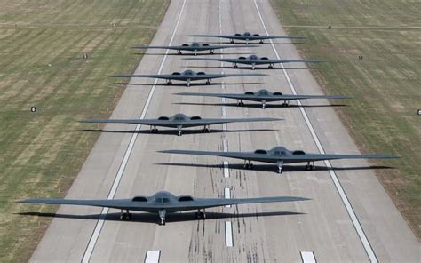 A formation of stealth bombers flying over a mountain range