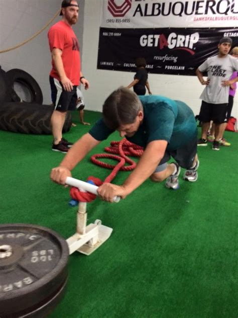 A person lifting weights, with a determined look on their face