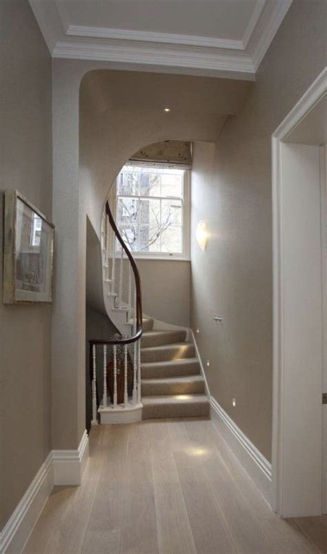 A hallway with taupe-colored walls and cream-colored trim