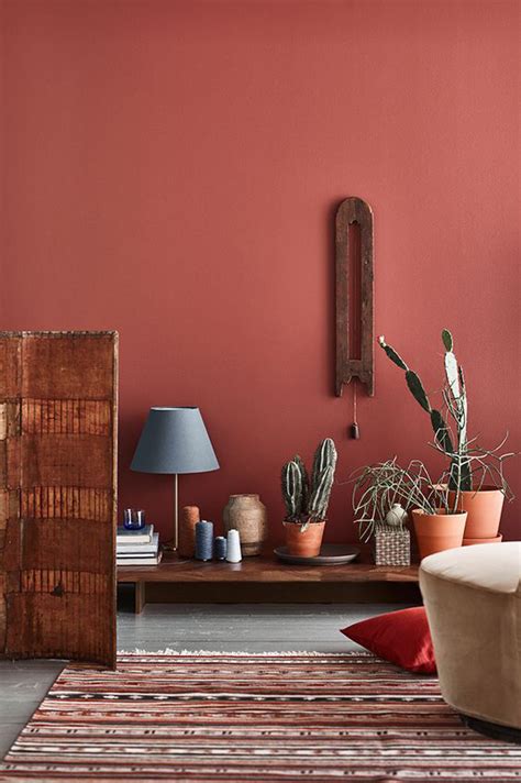 Terracotta-colored walls in a cozy bedroom retreat