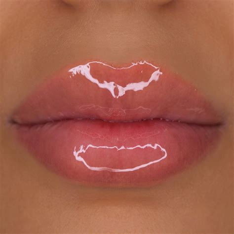 A transparent makeup palette featuring a variety of lip gloss shades