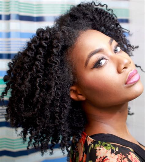 A young woman with 4c hair styled in a twist-out, paired with Air Force Ones