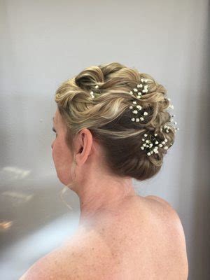 A young woman with 4c hair styled in an updo, paired with Air Force Ones