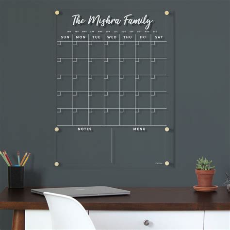 Family using a shared whiteboard calendar