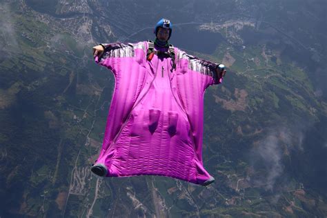 Wingsuit flying over a scenic landscape